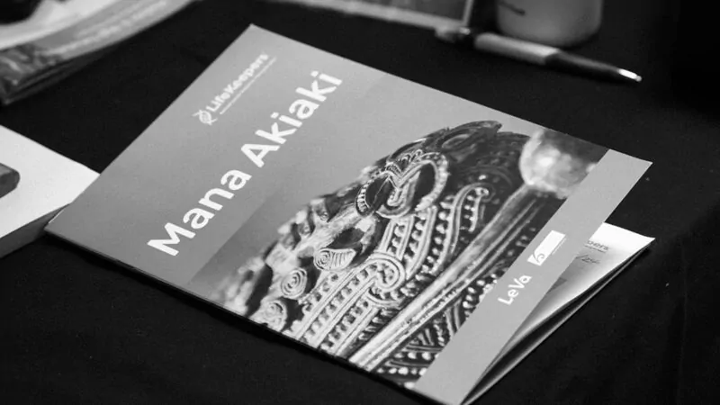 Black and white photo of Mana Akiaki workbook on a table