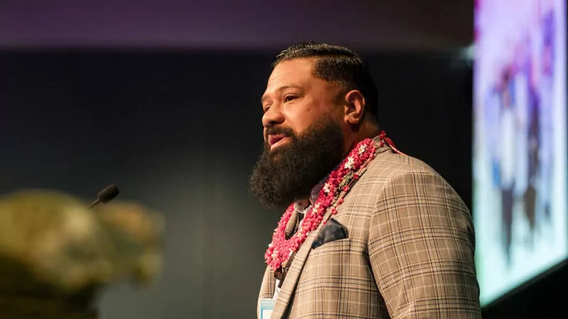 Ben Tameifuna speaking on stage