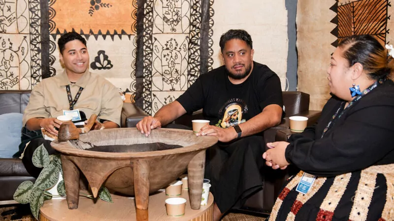 People seated around a large Tanoa in the End Game Kava Korner