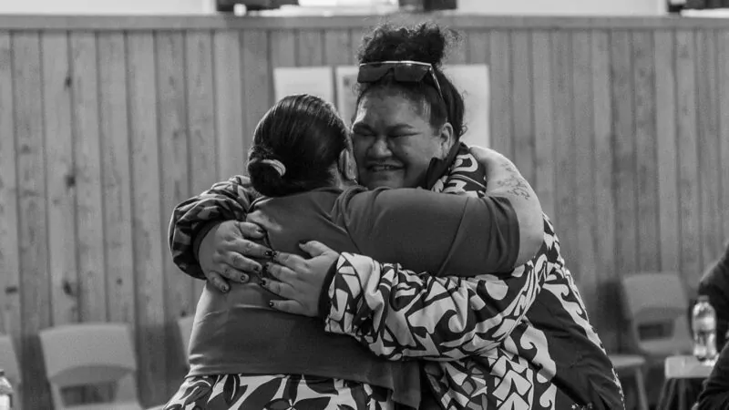 Two Pasifika women hugging and smiling